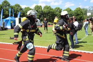 Zwei laufende Feuerwehrmänner mit Atemschutzmasken