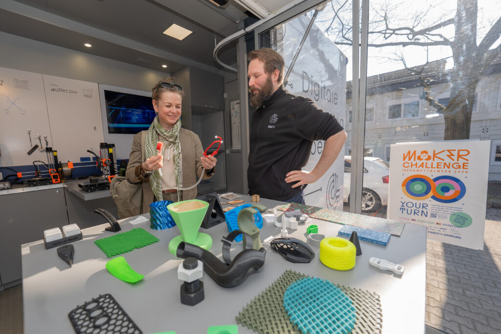 Wissenschaftlicher Mitarbeiter der Helmut‑Schmidt‑Universität erläutert der Generalkonsulin der Republik Polen 3D‑gedruckte Prototypen in einem Innovations‑ und Maker‑Space.